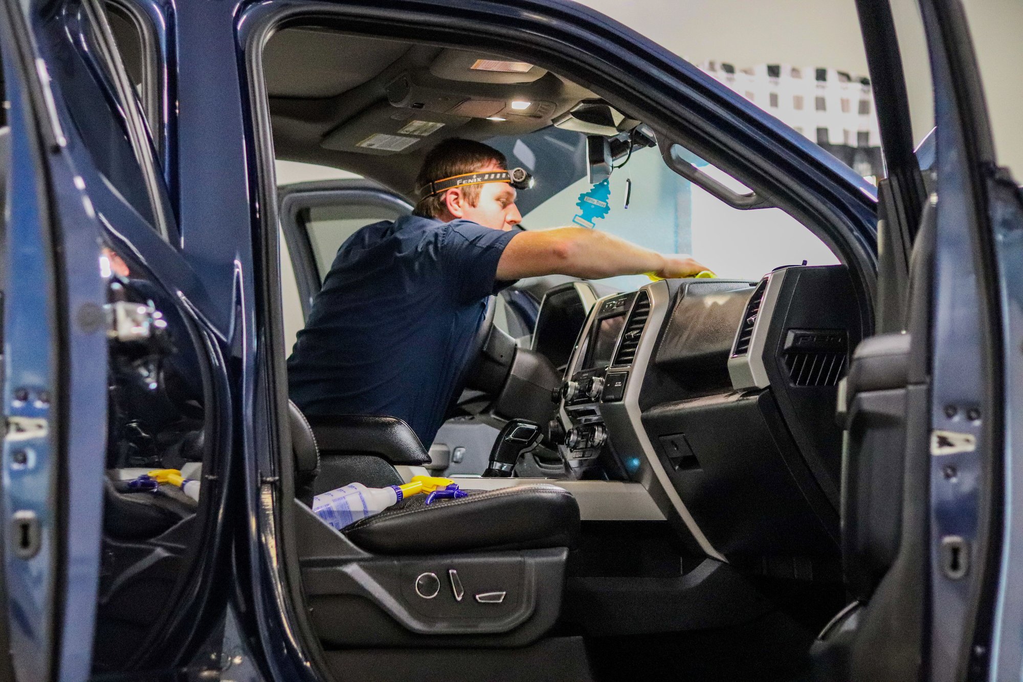 Man cleaning truck interior.